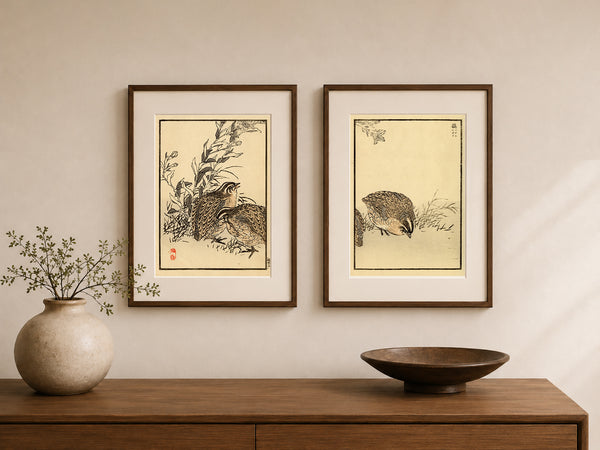 Two framed Japanese-style art prints depicting birds, displayed side-by-side on a beige wall above a wooden console table with a ceramic vase and a wooden bowl.
